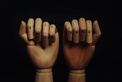 Close-up of human hand against black background