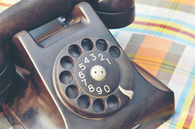 High angle view of telephone on wooden table