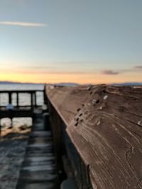 Close-up of wooden jetty on beach against clear sky