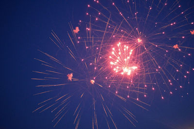 Low angle view of firework display at night