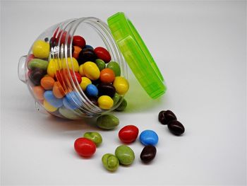 Close-up of colorful candies against white background