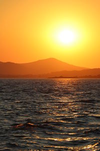 Scenic view of sea against orange sky