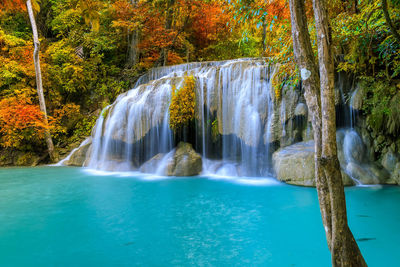 Colorful majestic waterfall in national park forest during autumn