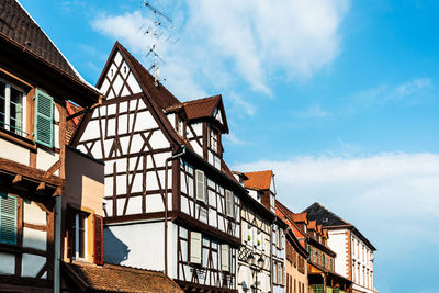 Low angle view of buildings against blue sky