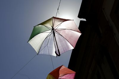 Low angle view of umbrellas against sky