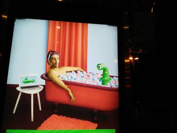 Portrait of shirtless man with toys on table