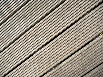 Diagonal closeup shot of wooden decking board suitable for use as a background