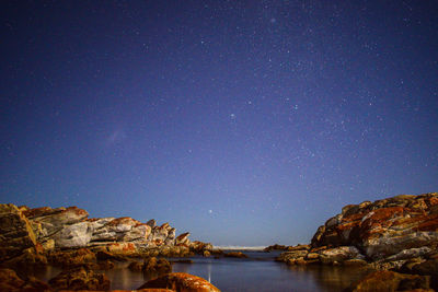 Scenic view of rock formation against sky at night