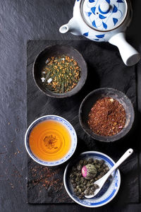 High angle view of various spices on slate