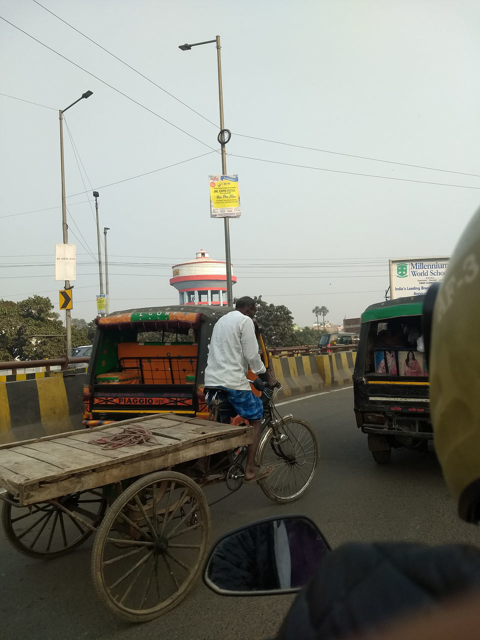 REAR VIEW OF A MAN RIDING BICYCLE ON ROAD