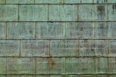 Oxidized copper folded sheet metal on roof. copper wall texture background. with marks and scrawls.