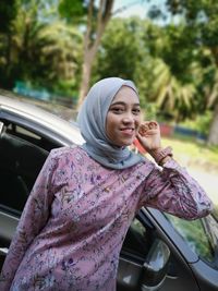 Portrait of smiling woman in car