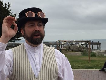 Mature man standing against sky