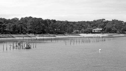 Scenic view of lake by building against sky