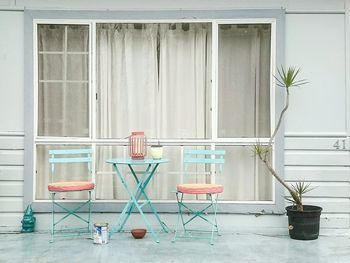 Table and chairs against window of house