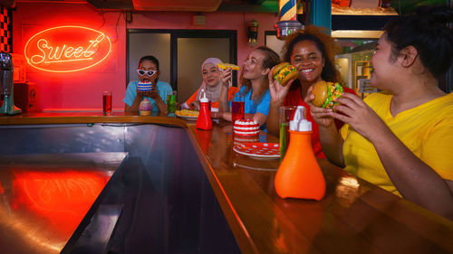 Cheerful people eating food at restaurant