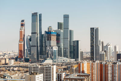 Modern buildings in city against clear sky