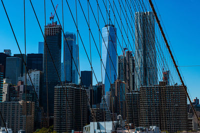 Low angle view of modern buildings against blue sky