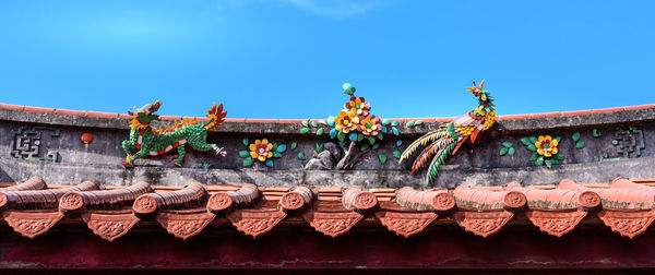 Low angle view of roof against clear blue sky