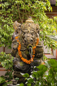 Close-up of elephant statue against trees