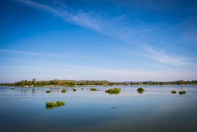 Scenic view of lake against blue sky