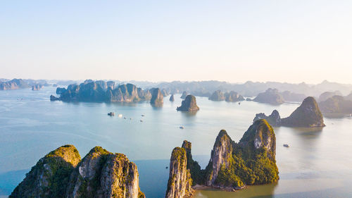 Panoramic view of rocks in sea against clear sky