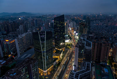 High angle view of illuminated city buildings at night