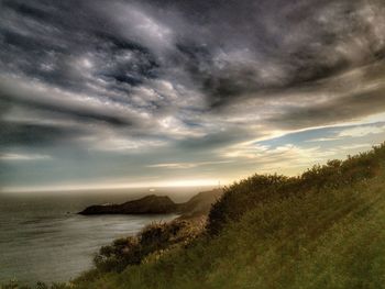 Scenic view of sea against cloudy sky