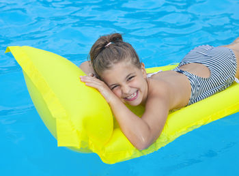 High angle portrait of smiling boy in swimming pool