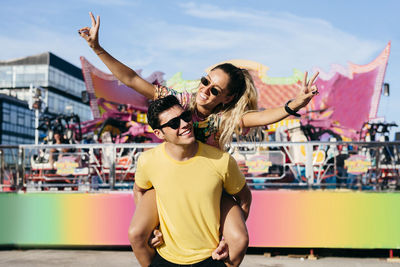 Young man and woman wearing sunglasses