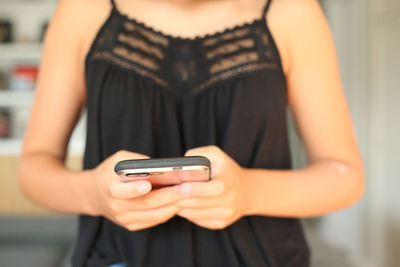 Midsection of man using mobile phone