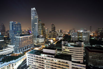 Illuminated cityscape against sky at night