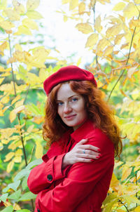 Young happy woman with red hair, freckles, blue eyes in beret in autumn park, smiling. lifestyle