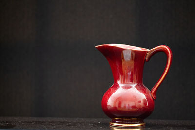 Close-up of red drink on table against black background