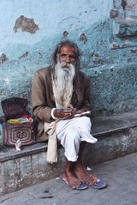 Portrait of man holding umbrella