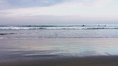 Scenic view of sea against cloudy sky