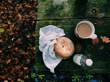 High angle view of bagel and coffee on table during autumn