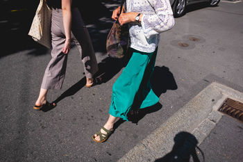 Low section of people walking on road