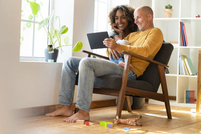 Friends sitting on table at home