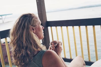 Close-up of young woman sitting outdoors