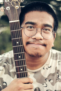 Portrait of a young man playing guitar