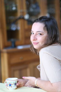 Portrait of young woman with coffee