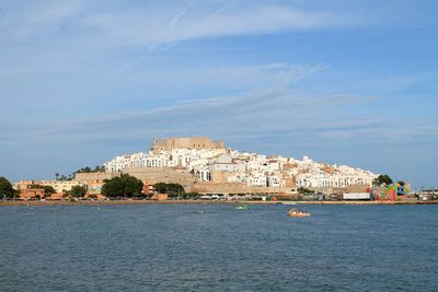 View of castle by sea against sky