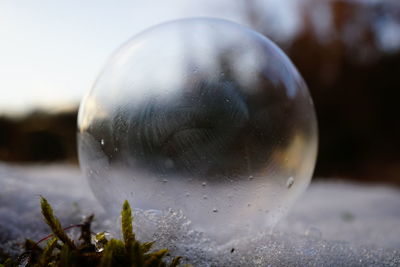 Close-up of crystal ball against blurred water