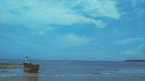 Scenic view of sea against cloudy sky