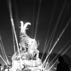Low angle view of illuminated people at night