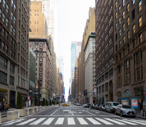 City street amidst buildings against sky