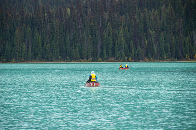 People kayaking in sea