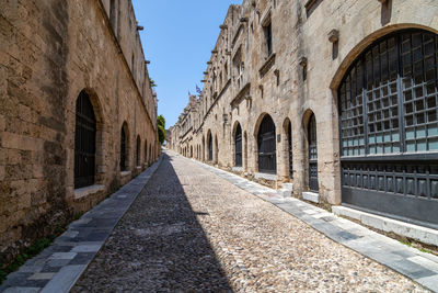 Street amidst old buildings against clear sky