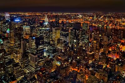 Aerial view of city lit up at night